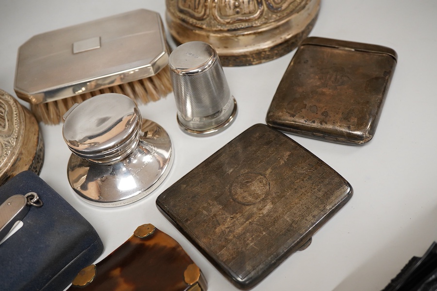 A George V silver top opening cigarette case, Birmingham, 1923, 83mm, together with a silver mounted hair brush, one other silver cigarette case, a silver mounted cigar cutter, a silver mounted inkwell, a large silver th